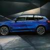 Side view of a fully loaded new blue 2022 BMW X5 M