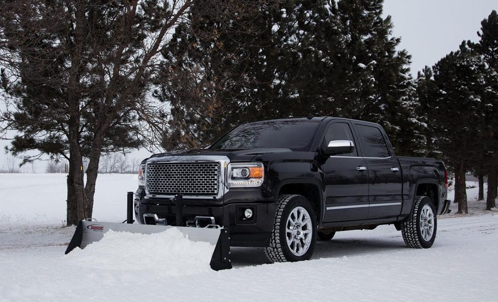 A Black pickup truck with a SnowSport HD snow plow on the front.