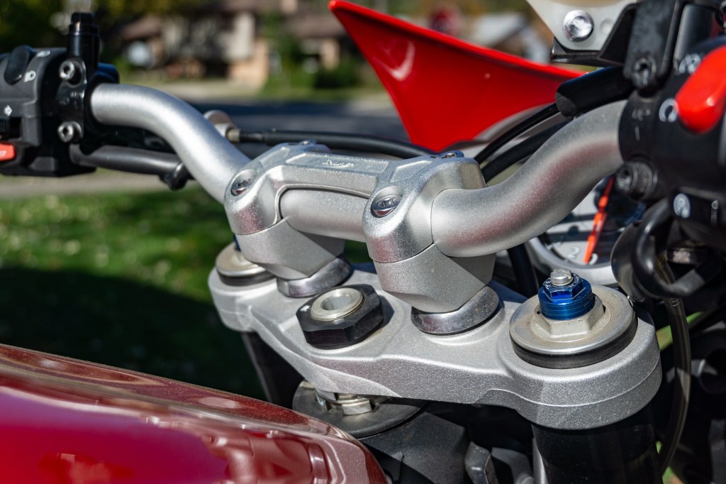 The stock position of a red 2012 Triumph Street Triple R's handlebar