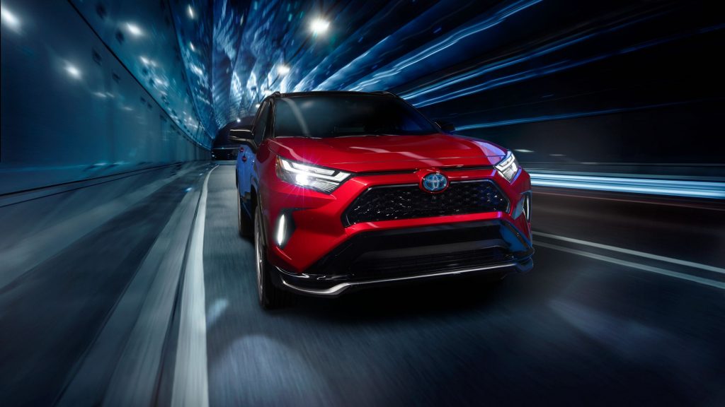 Supersonic Red 2022 Toyota RAV4 Prime plug-in hybrid (PHEV) driving through a tunnel