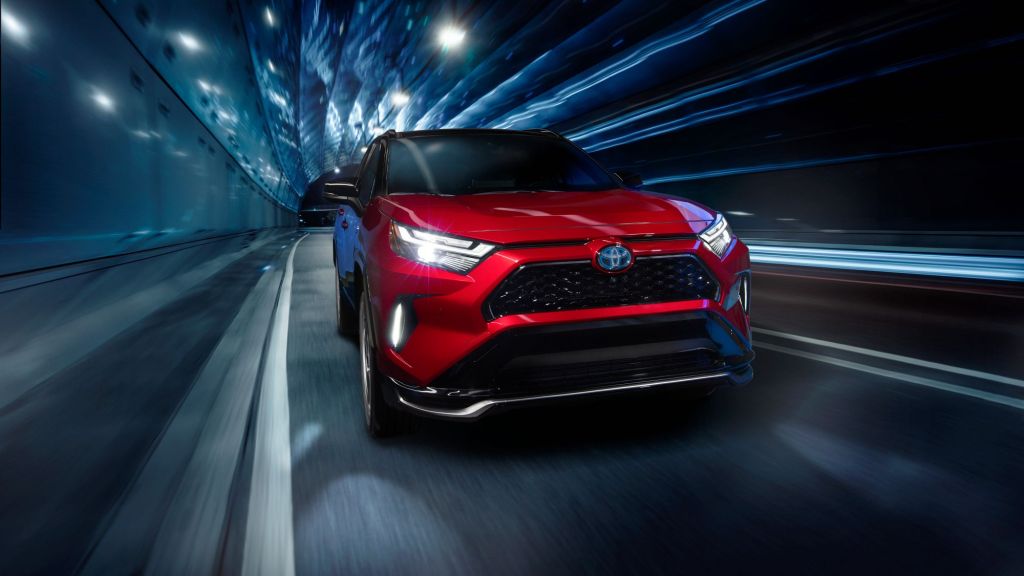 Supersonic Red 2022 Toyota RAV4 Prime driving through a tunnel