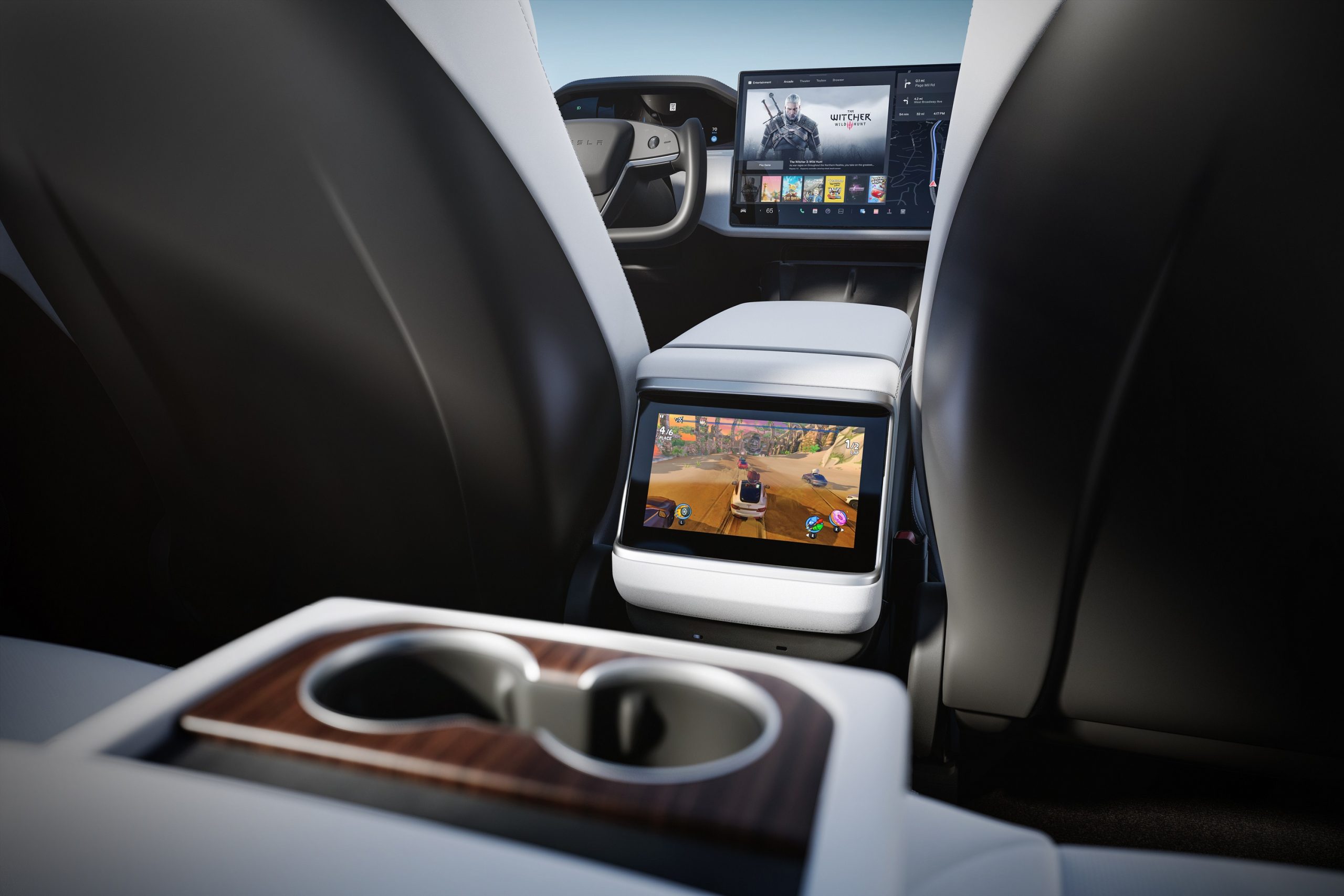 The interior of a Tesla Model S displaying video games on the rear screen