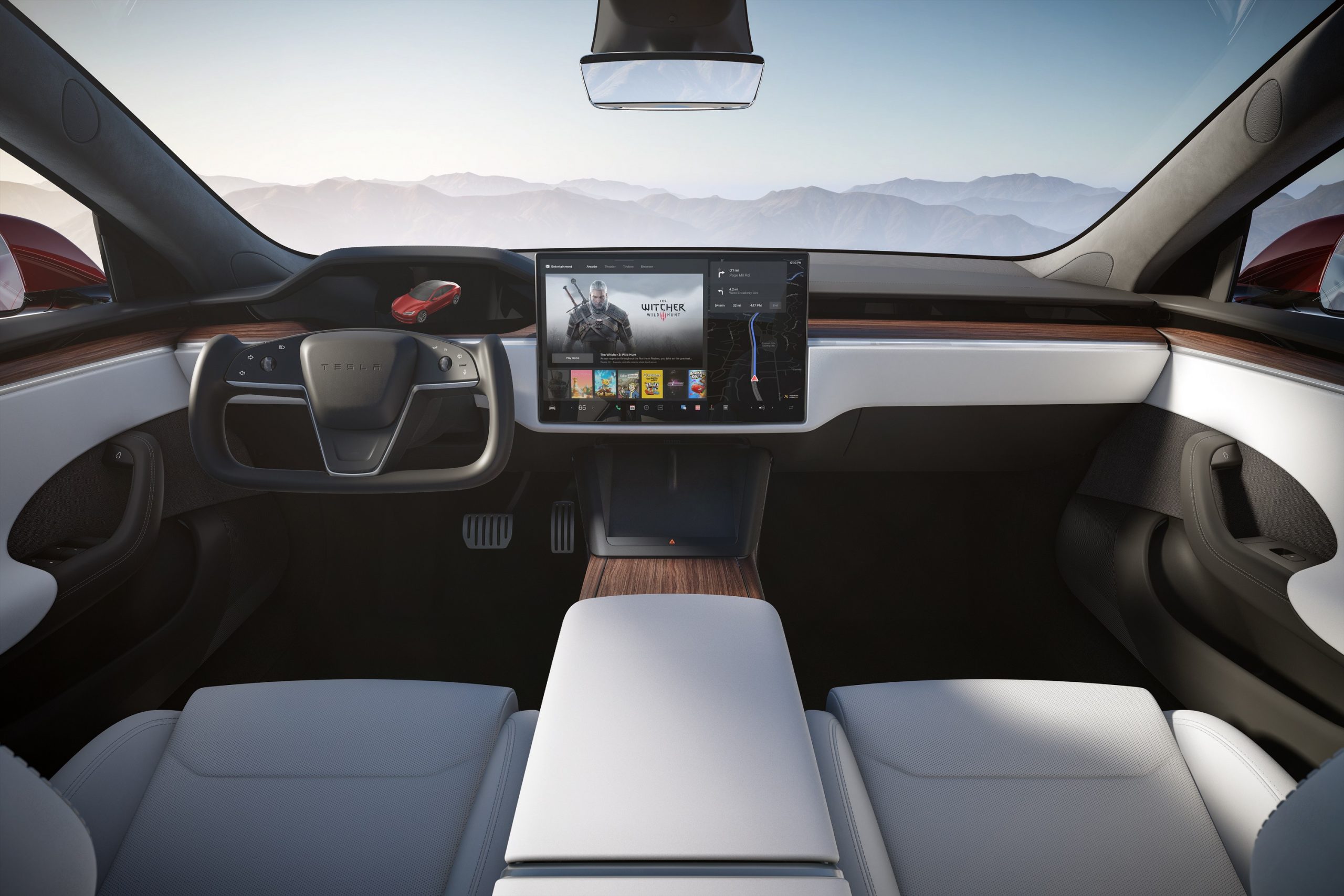 The interior of a Tesla Model S sedan displaying video game content on the center screen