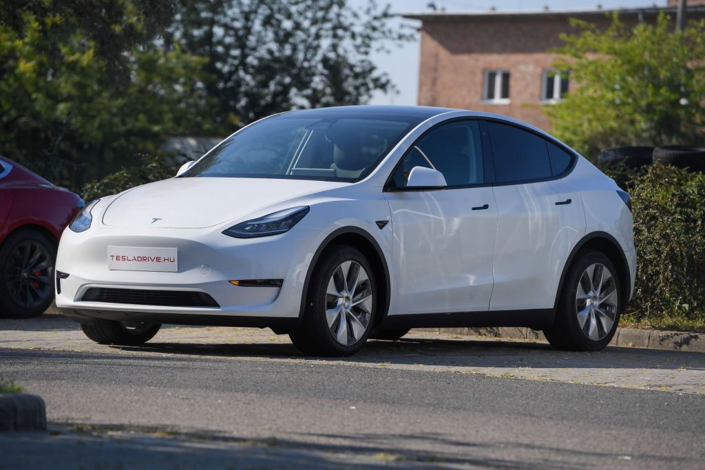 A Tesla Model Y electric compact luxury SUV with a white paint color option