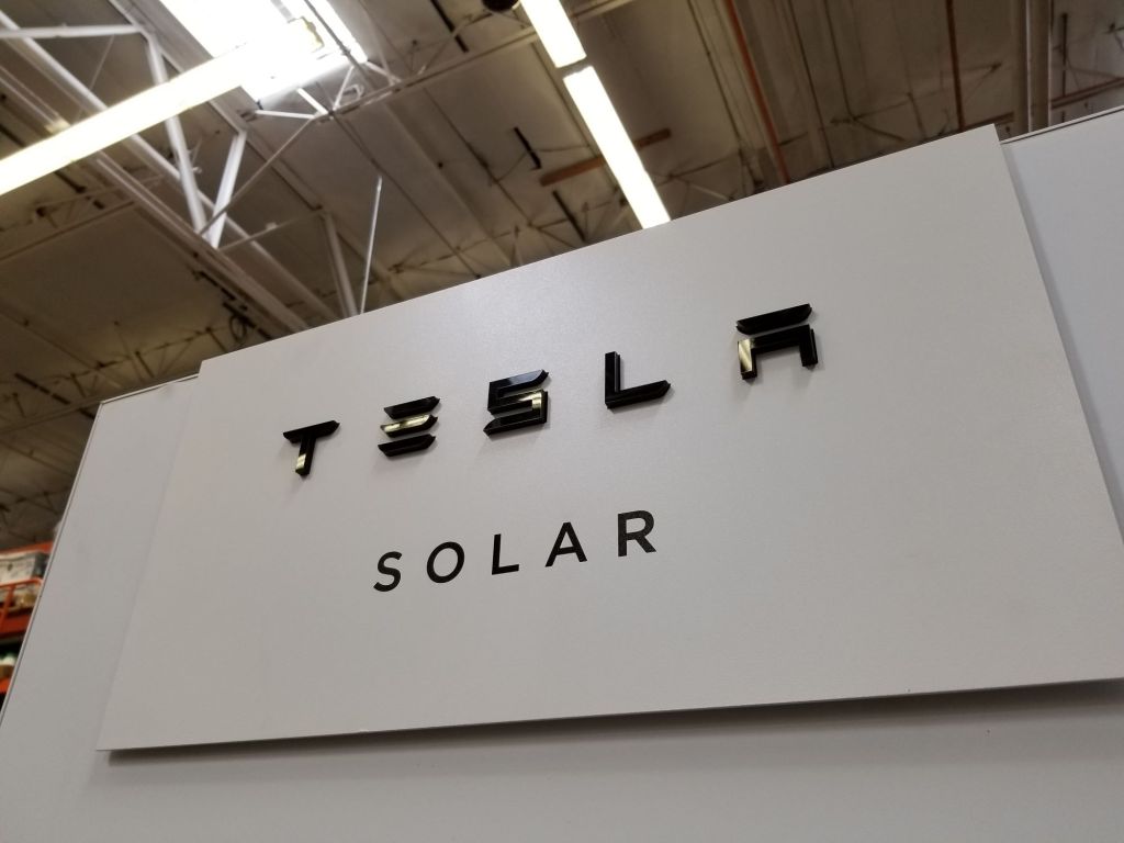 Tesla Solar sign inside of an industrial building. 
