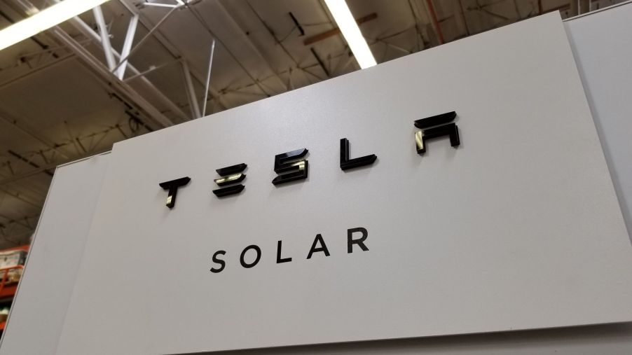 Tesla Solar sign inside of an industrial building.
