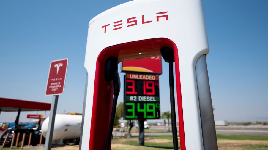 A Tesla charging station in front of a gas station in Ehrenberg, Arizona