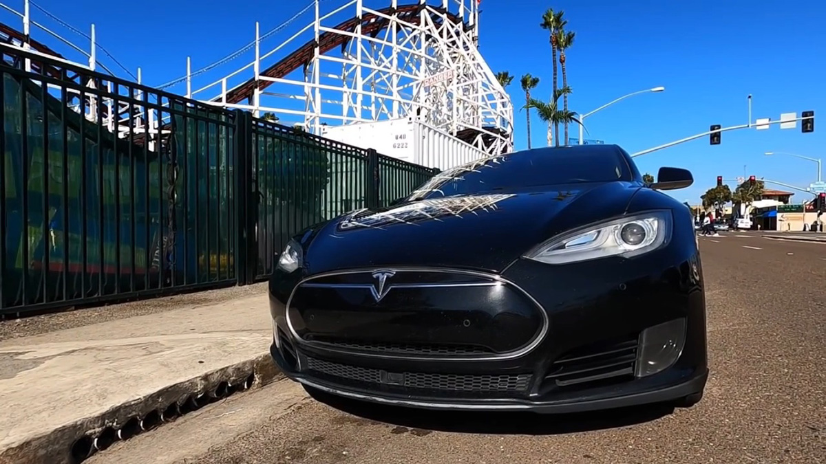 Black 2015 Tesla Model S parked in front of Giant Dipper Rollercoaster in San Diego, California