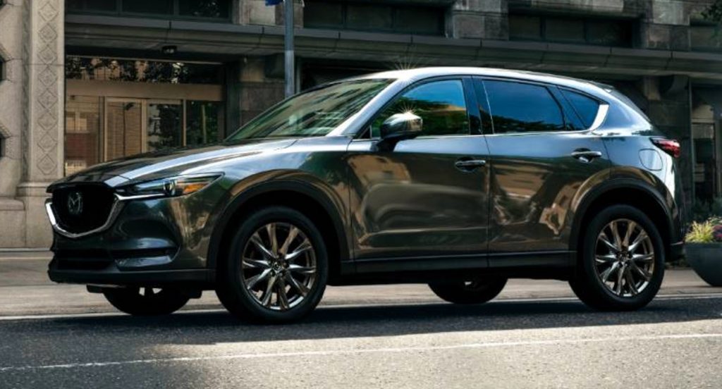 A black Mazda CX-5 is parked on the street. 