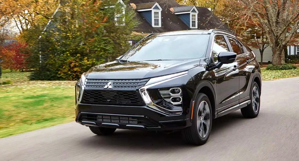 A black Mitsubishi Eclipse Cross is driving down the road. 