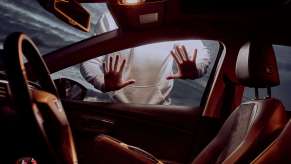 Thief getting ready to steal a car on New Year's, the holiday with the highest number of cars stolen