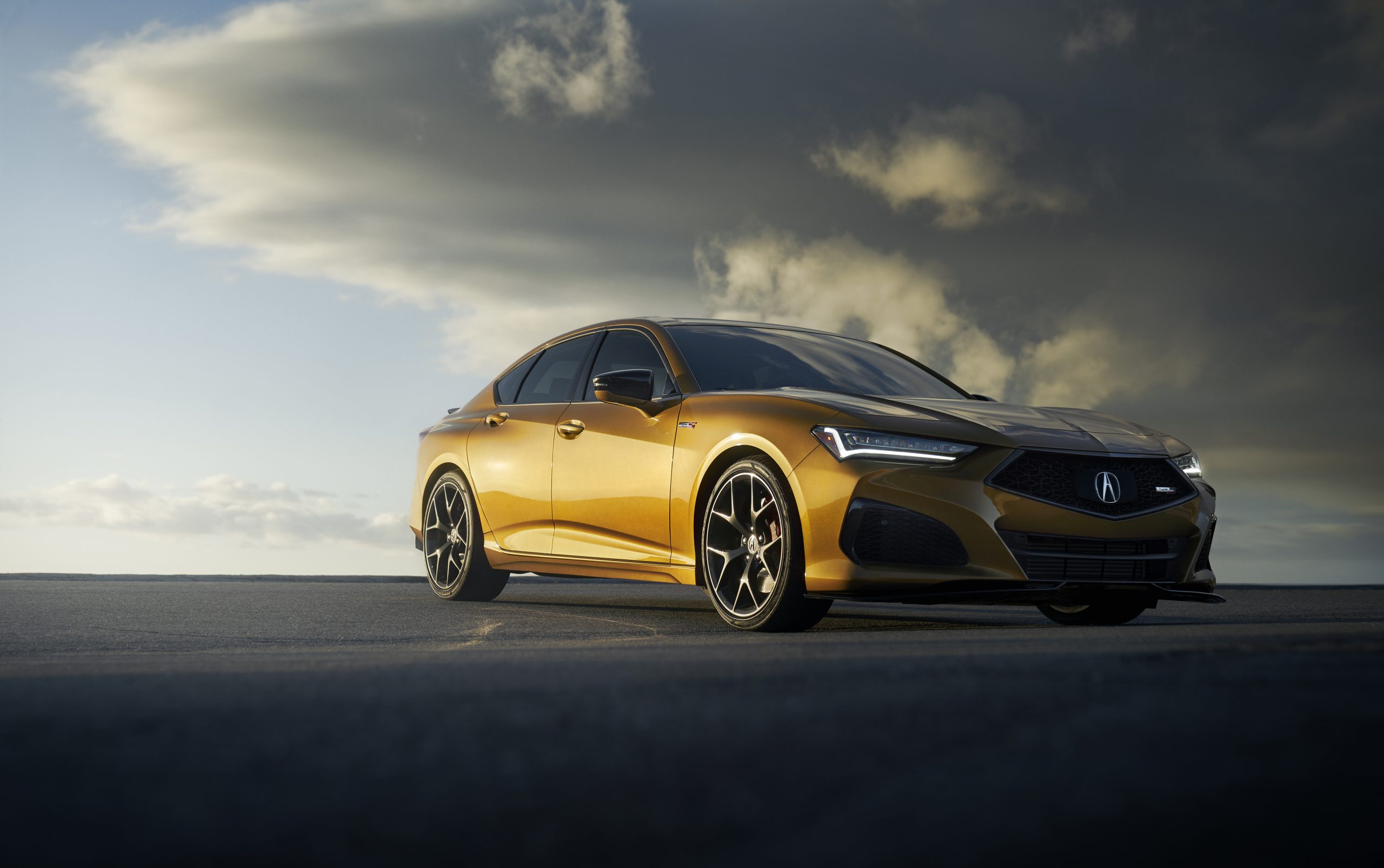 A Tiger Eye Pearl 2022 Acura TLX Type S shot on a cloudy day