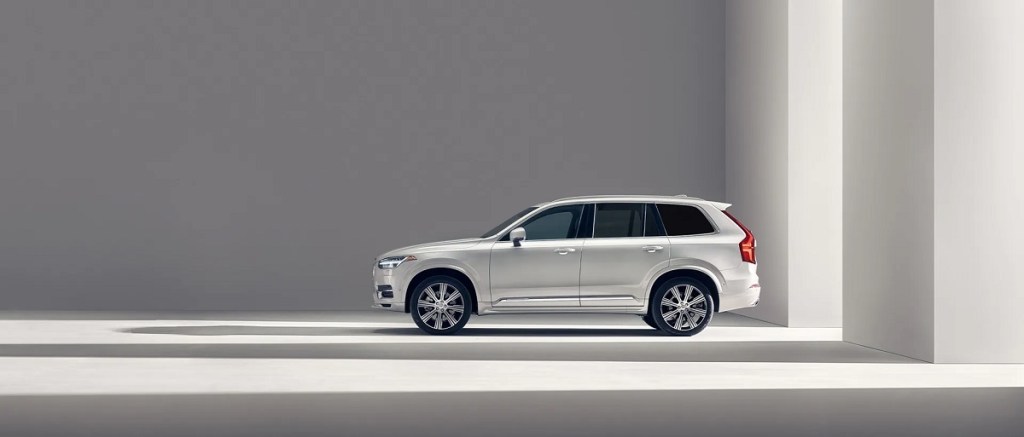 A white Volvo XC90 against a gray background.