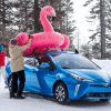 Woman placing a pink inflatable on a 2022 Toyota Prius