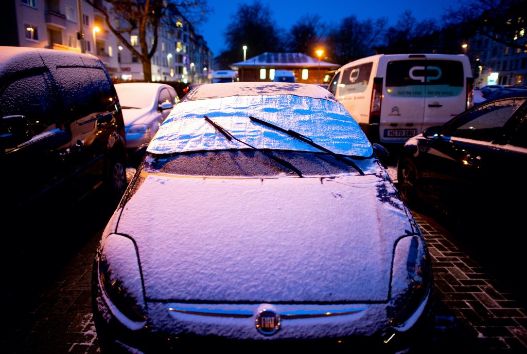  An antifreeze blanket protects the windshield of a car parked in Südstadt from snow and ice.