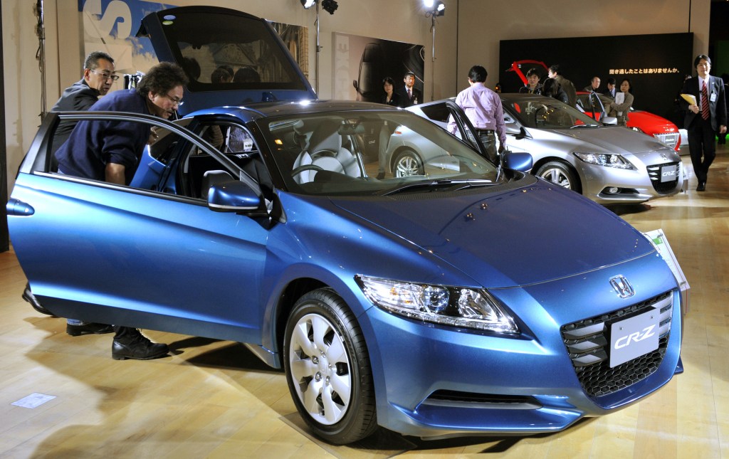 Journalists inspect the new hybrid sports car "CR-Z" from Honda Motor