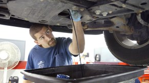 A vehicle gets an oil change in a service garage