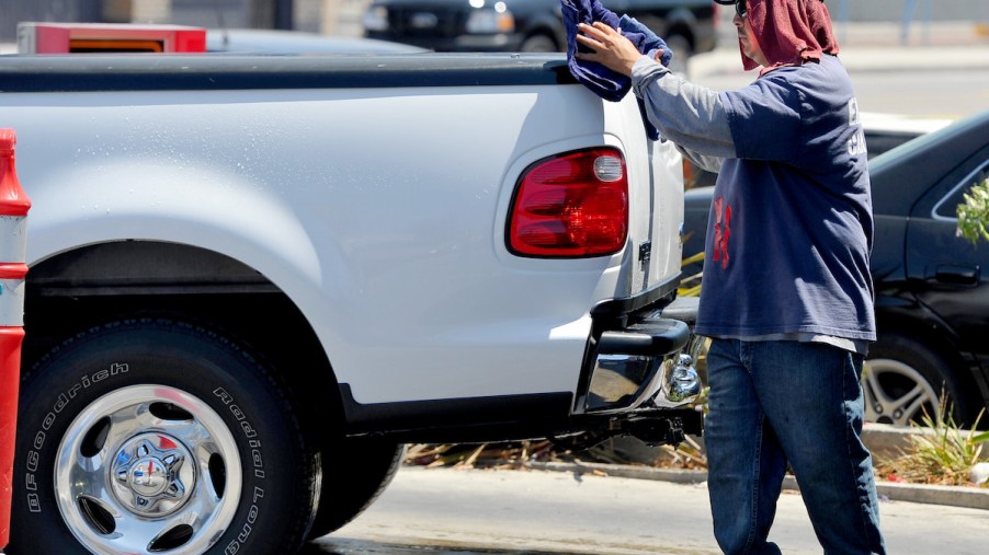 A worker at Tommy's Car Wash dries a truck with a tow hitch in Long Beach, California, in July 2014