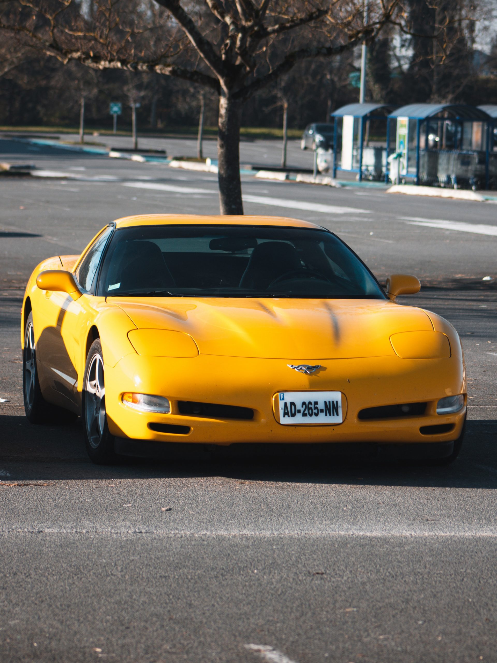 A yellow Chevrolet Corvette shot from the front 3/4 angle