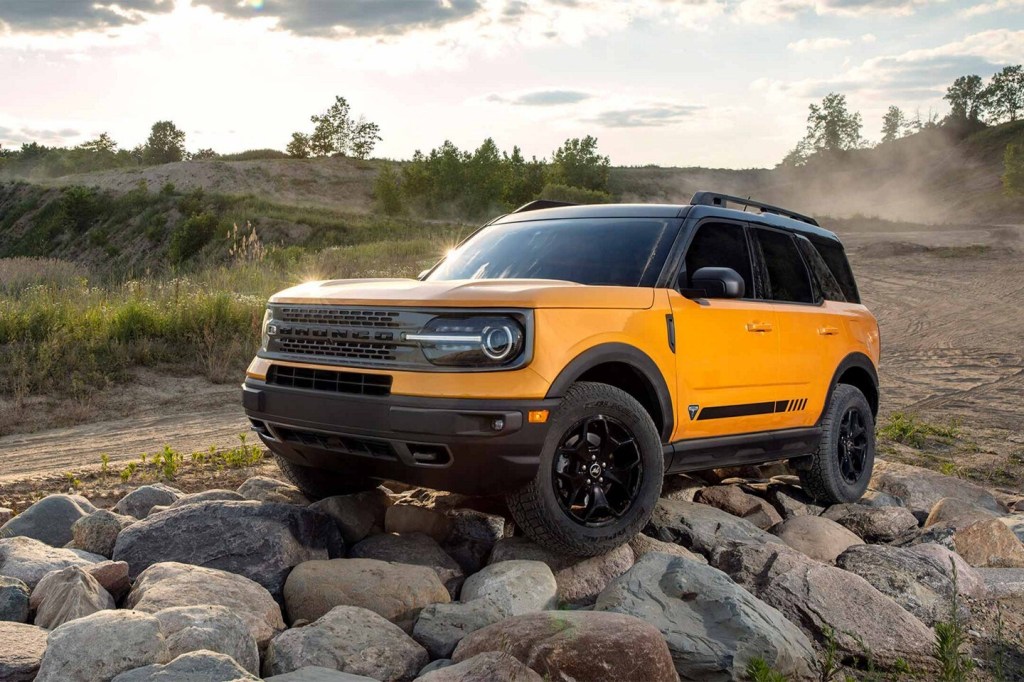 A yellow 2021 Ford Bronco Sport on rocks.