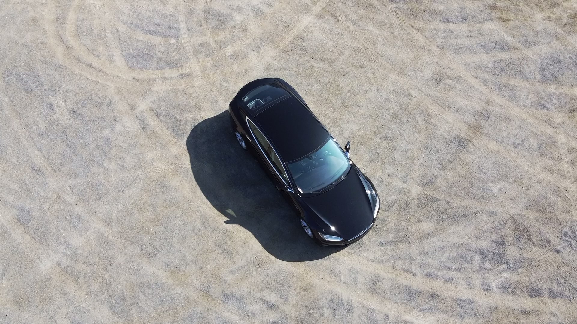 A roof-down shot of a black Model S EV