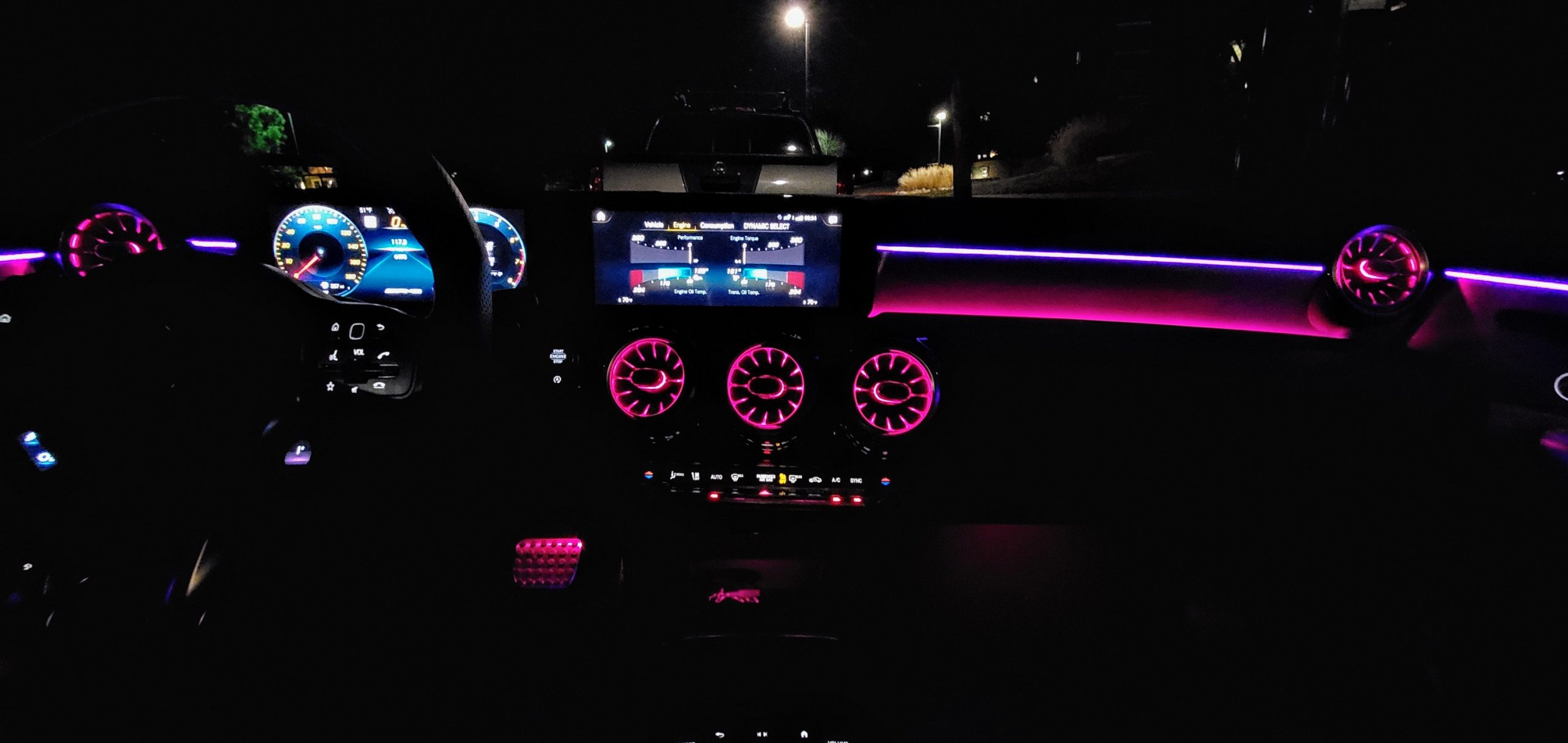 The interior of the AMG A35 illuminated by its ambient lighting at night