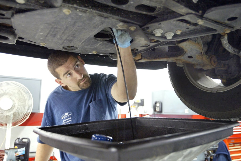Automotive service technician Steve Loverme works on a vehicle at Bredemann Chevrolet December 5, 2003 in Park Ridge, Illinois.