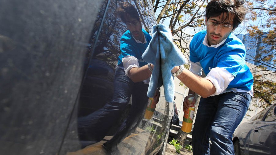 Washly CEO Karan Walia uses a waterless car wash on a vehicle
