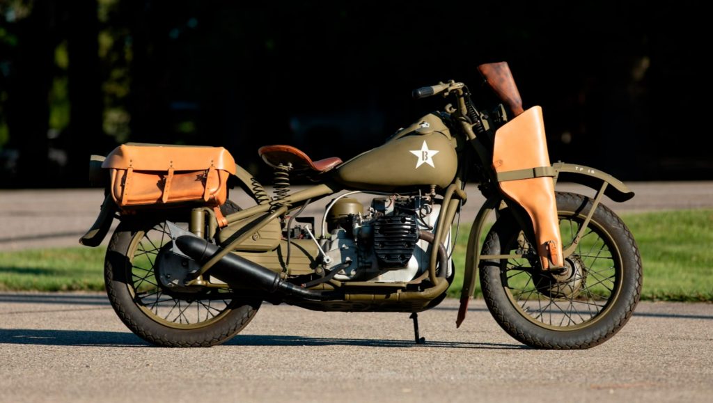 The side view of a matte-green 1942 Harley-Davidson XA side with saddlebags and gun holster