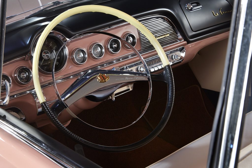 The pink-and-black dashboard and pink front seats of a 1955 Dodge La Femme