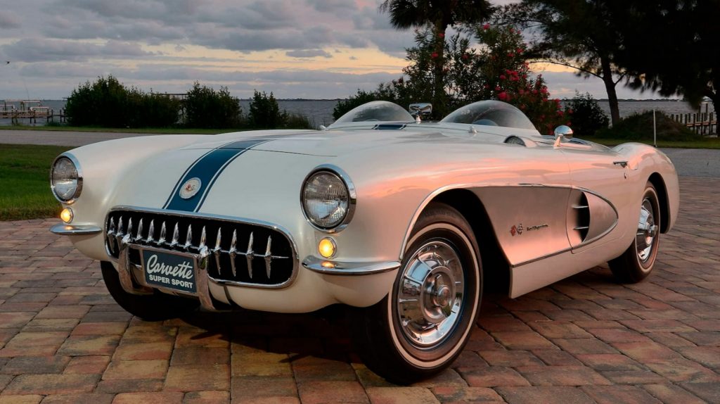 The white-with-blue-stripes 1957 Chevrolet Corvette Super Sport next to the ocean