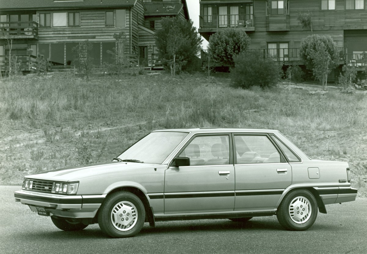 A black and white press photo of the 1983 Toyota Camry sedan.