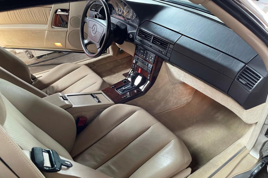 The tan-leather seats and black dashboard of a 1995 R129 Mercedes SL 320
