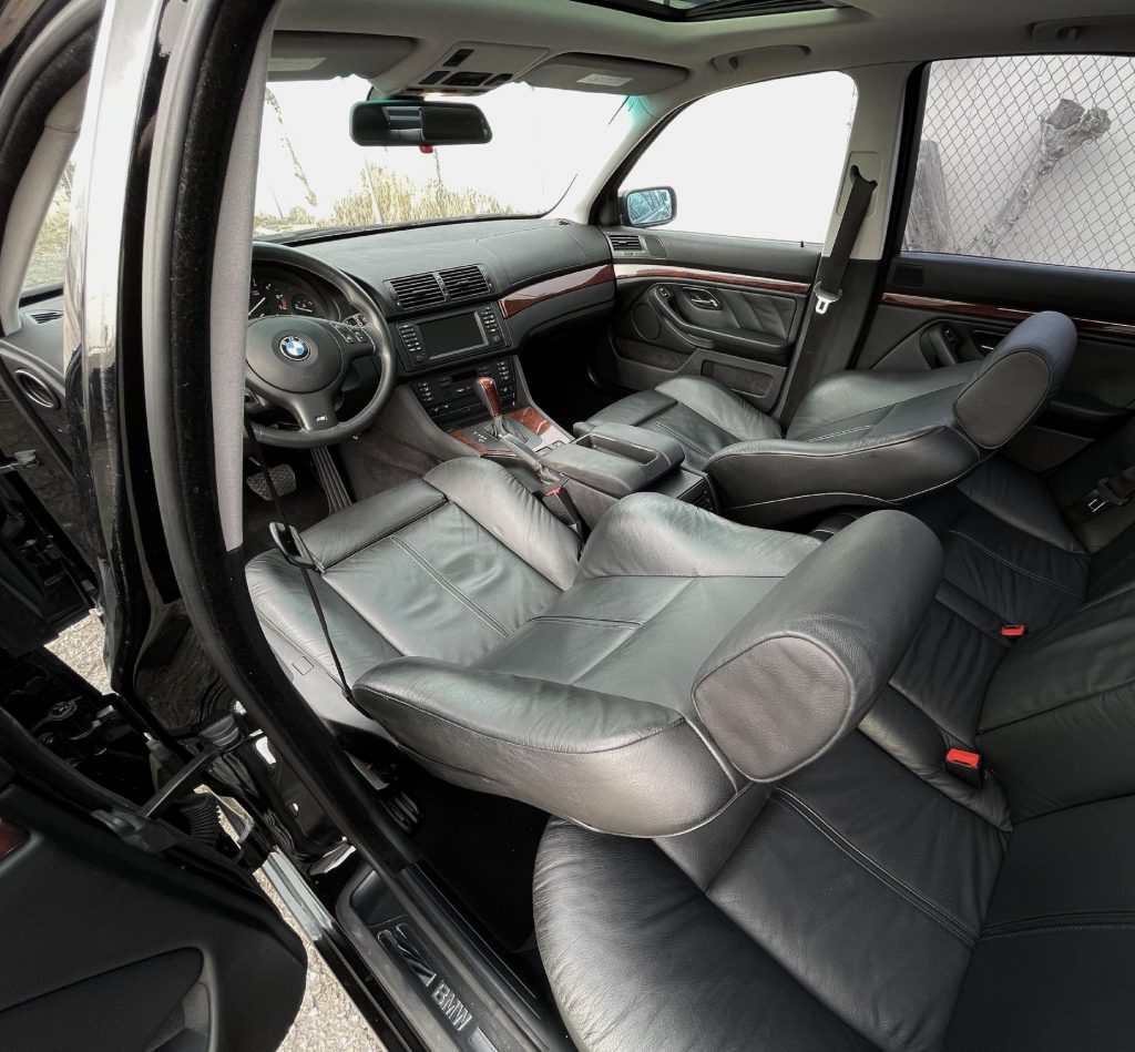 The black-leather interior of a black 2003 E39 BMW 530i with Sport Package