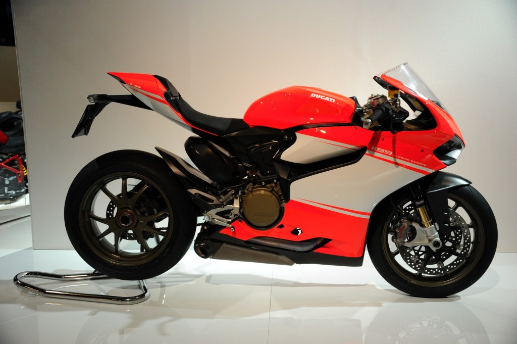 A red-and-white 2014 Ducati 1199 Panigale Superleggera on a rear-wheel stand on a stage