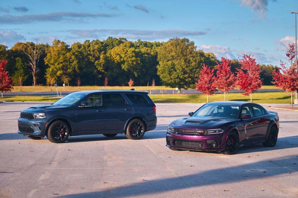 The 2021 Dodge Durango SRT Hellcat and 2021 Charger SSRT Hellcat Redeye in a parking lot | Stellantis