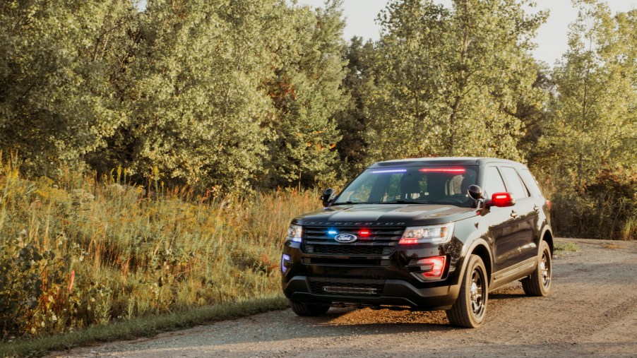 This is a promo photo of an unmarked Ford Police car with red and blue lights