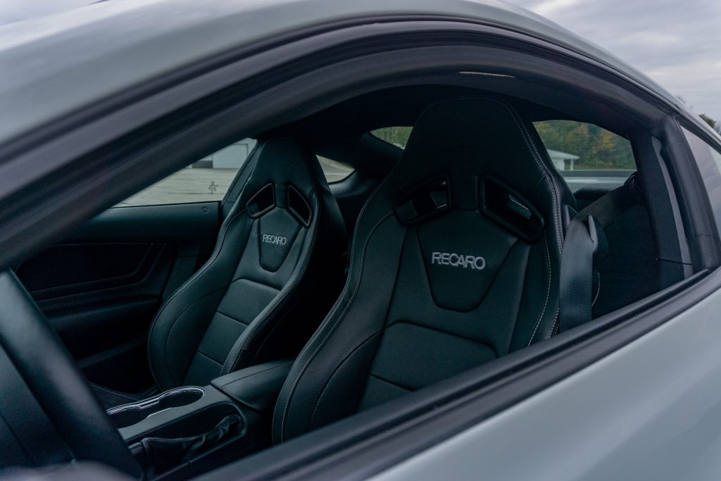 The black cloth-and-leather optional Recaro seats in a gray 2021 Ford Mustang Mach 1