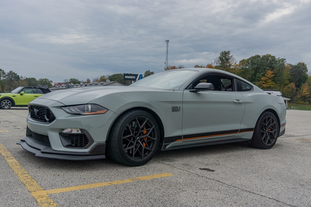 The front 3/4 view of a gray-and-black 2021 Ford Mustang Mach 1 with Handling Package at Road America