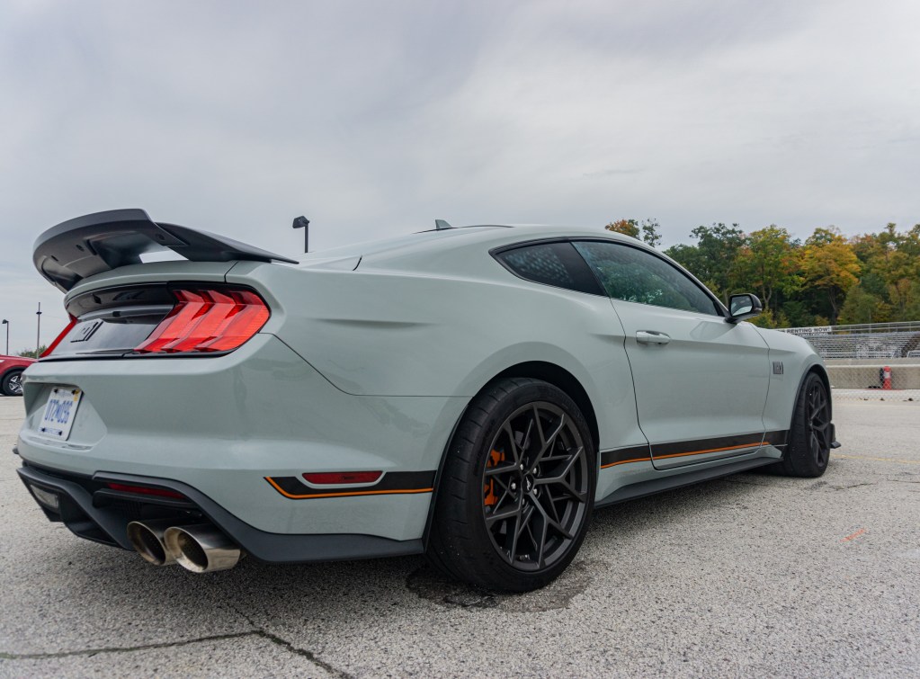 The rear 3/4 view of a gray-and-black 2021 Ford Mustang Mach 1 with Handling Package at Road America