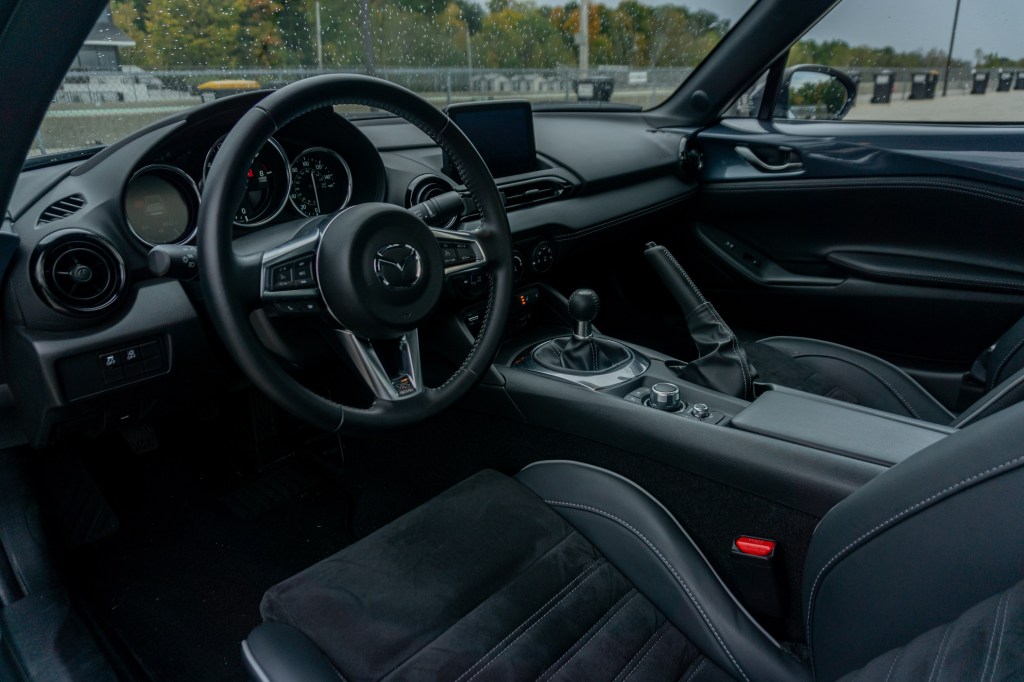 The black Recaro seats and black dashboard of a manual 2021 Mazda MX-5 Miata Club RF with Brembo BBS Recaro Package