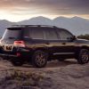 2021 Toyota Land Cruiser full-size off-road SUV model parked on top of a hill in a desert mountain range
