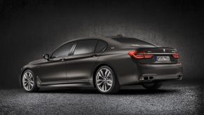 The rear 3/4 view of a dark-gray 2022 BMW M760i xDrive