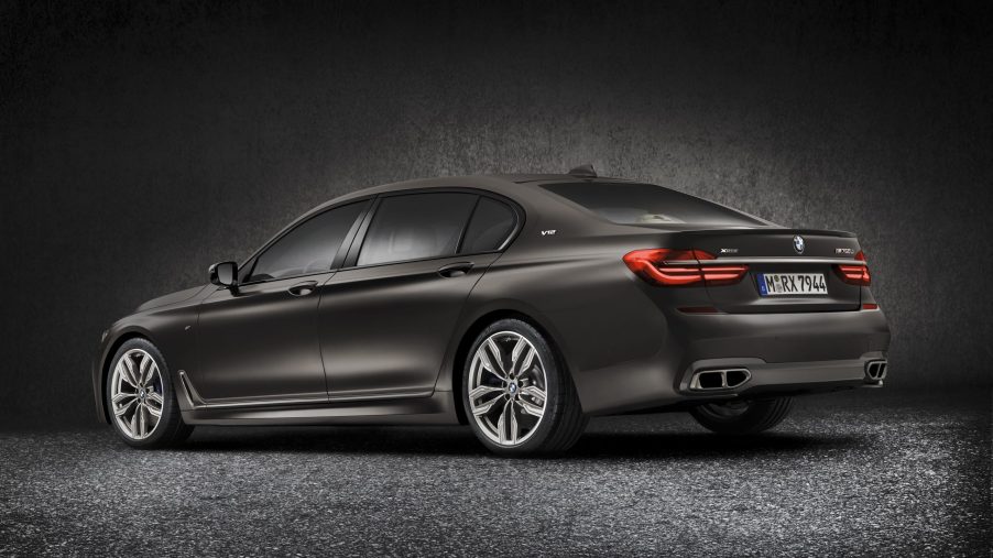 The rear 3/4 view of a dark-gray 2022 BMW M760i xDrive
