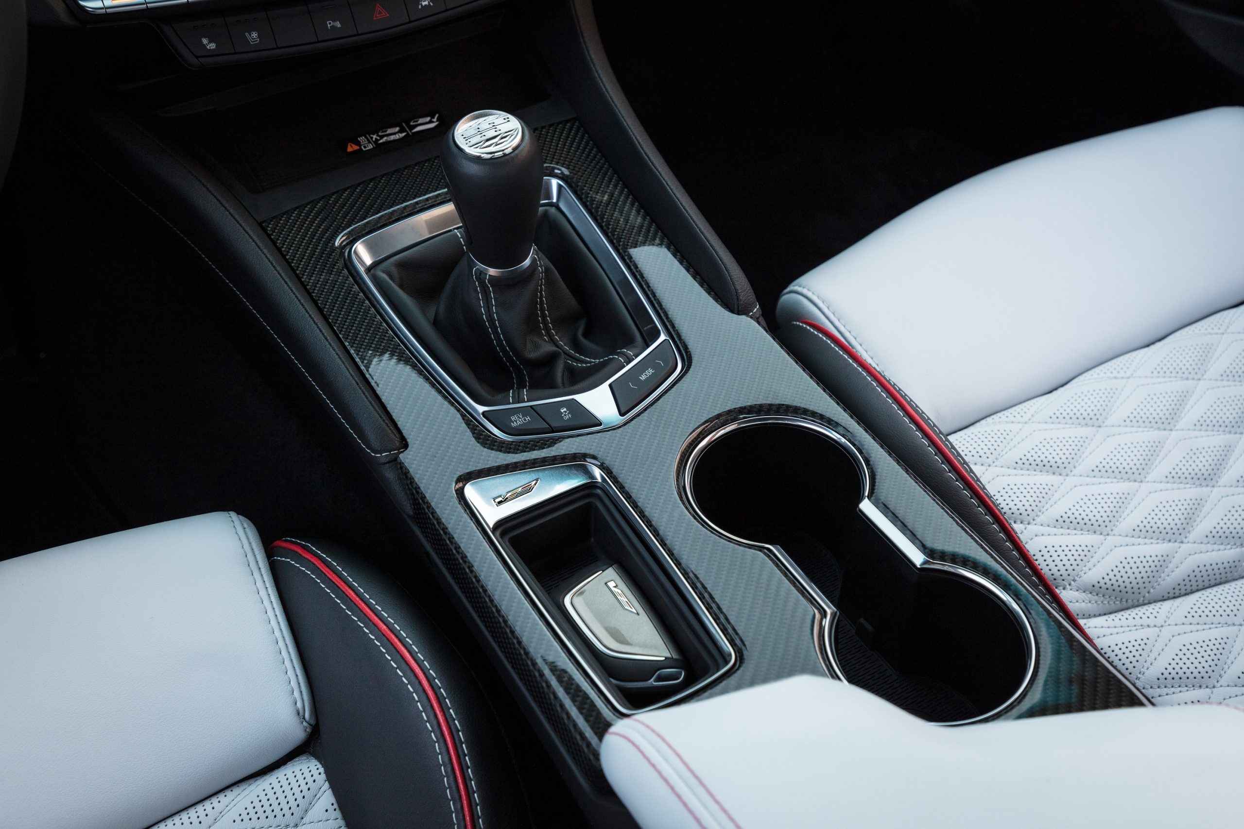The carbon-fiber center console of a 2022 Cadillac CT4-V Blackwing with a manual transmission