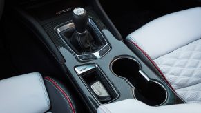 The carbon-fiber center console of a 2022 Cadillac CT4-V Blackwing with a manual transmission