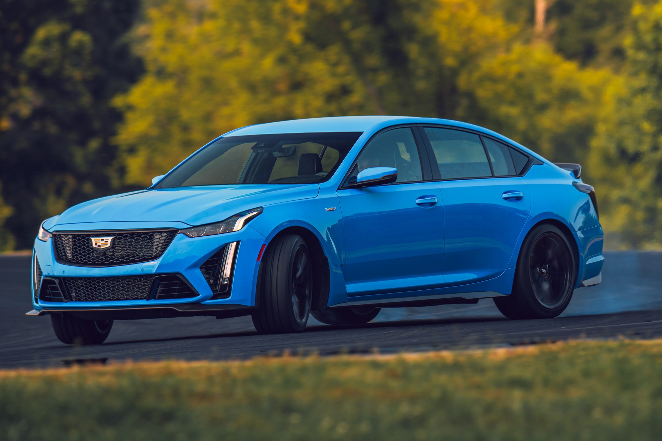 A blue 2022 Cadillac CT5-V Blackwing mid drift on a race track