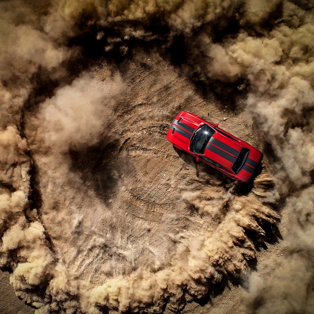 Dodge is looking for the 2022 Dodge Chief Donut Maker. This photo shows a  Hellcat ripping a donut in the dirt.