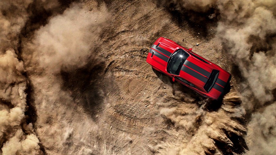 Dodge is looking for the 2022 Dodge Chief Donut Maker. This photo shows a Hellcat ripping a donut in the dirt.