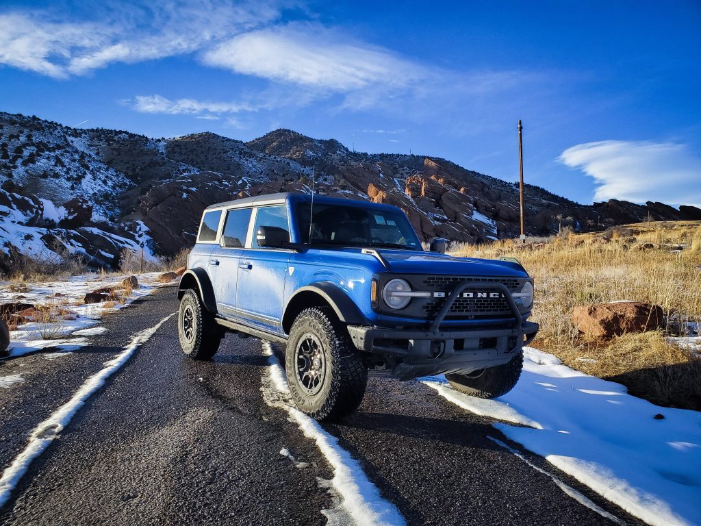 A blue 2022 Ford Bronco off-road SUV shot from the front 3/4